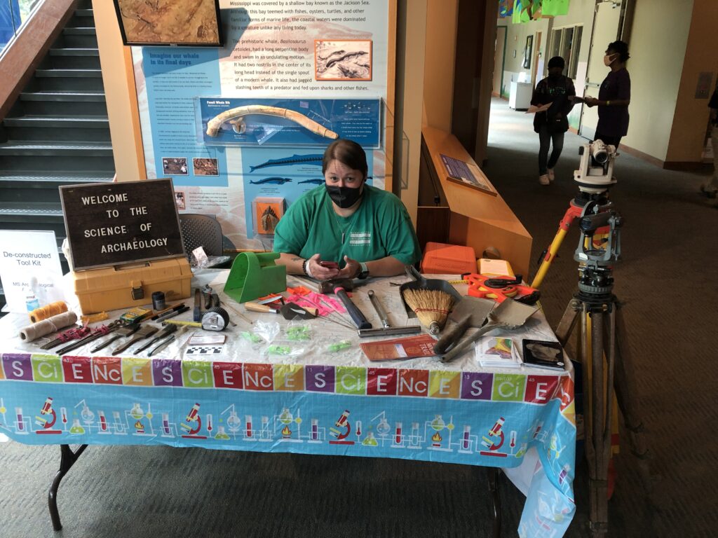 Woman wearing green shirt sitting.